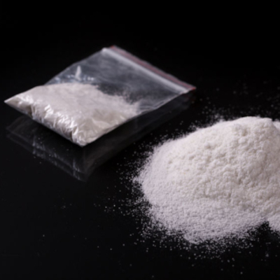 cocaine powder on a flat surface and in a plastic bag