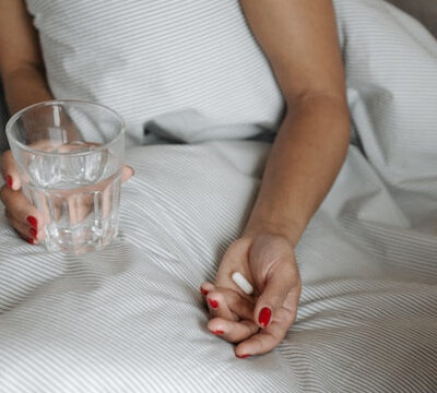 woman-in-bed-taking-medications