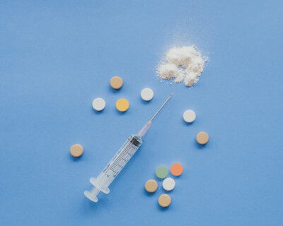 heroin powder, pills and a syringe