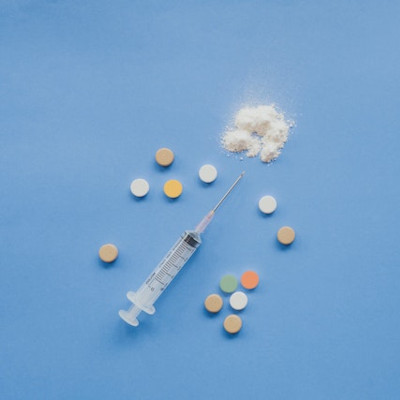 heroin powder, pills and a syringe