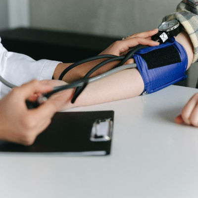 Doctor measuring blood pressure to a patient