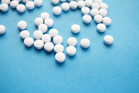 white pills on blue bacground