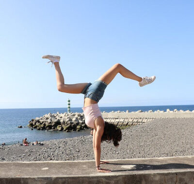 woman full of energy doing handstand