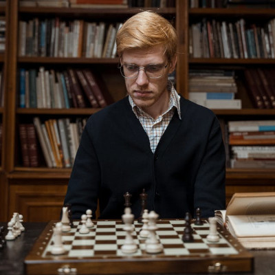 man looking at a chess table, focused