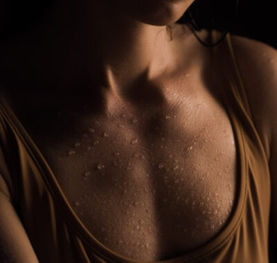 sweat drops on woman's chest, stress sweating