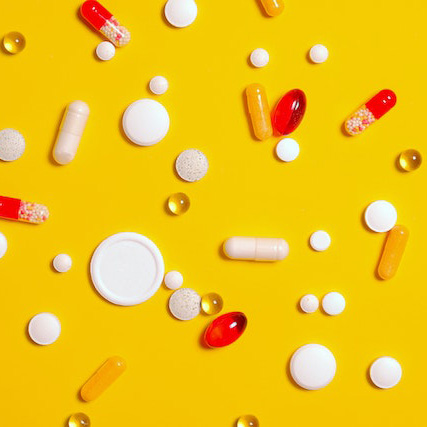 tablets and pills on a yellow background