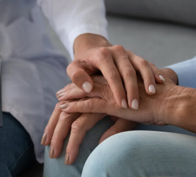 medical nurse, hands touching as a sign of support