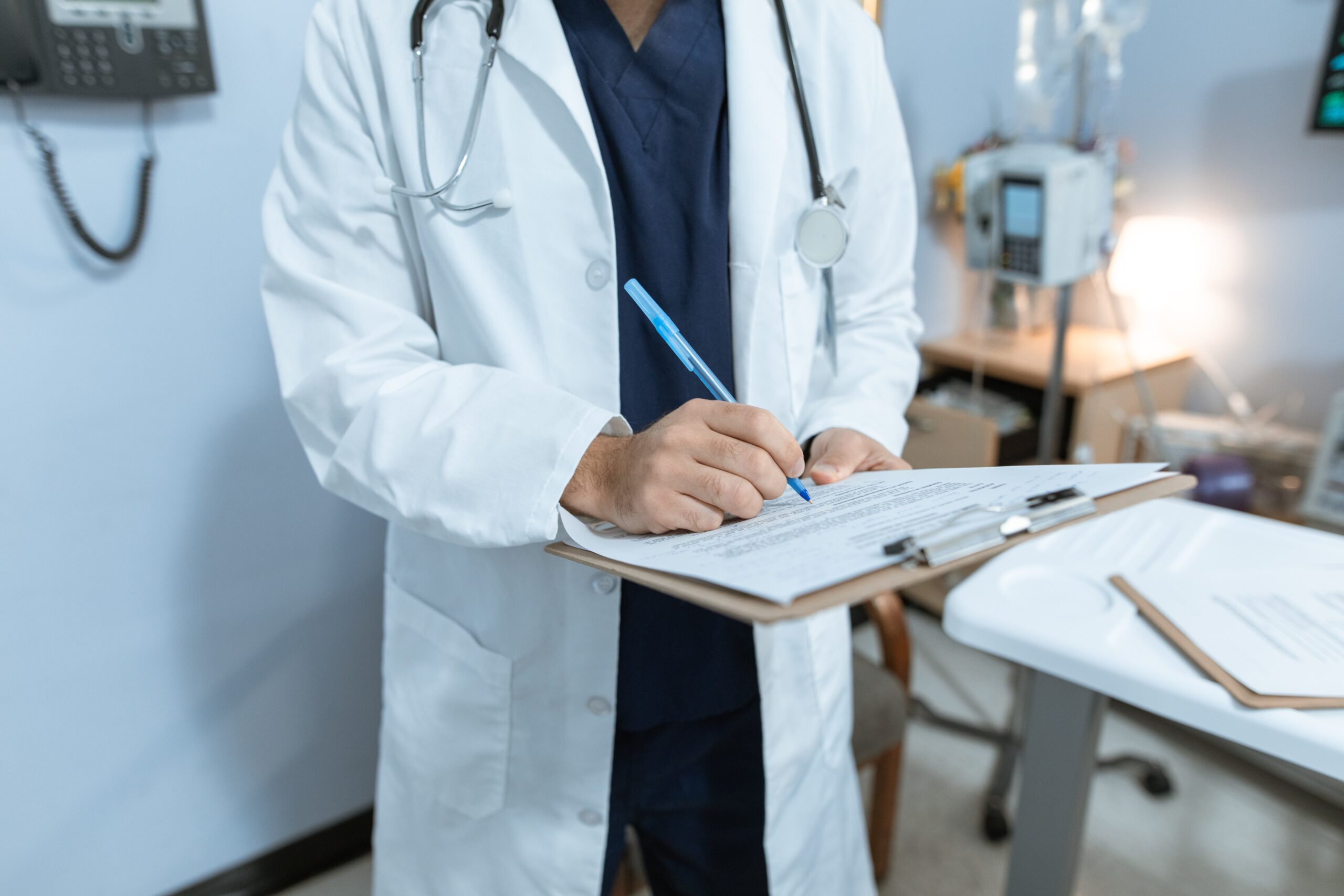 Doctor with a chart standing in his office