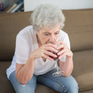 older woman drinking wine