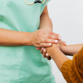 nurse holding hands with a patient