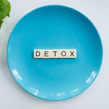 blue plate with tiles spelling detox