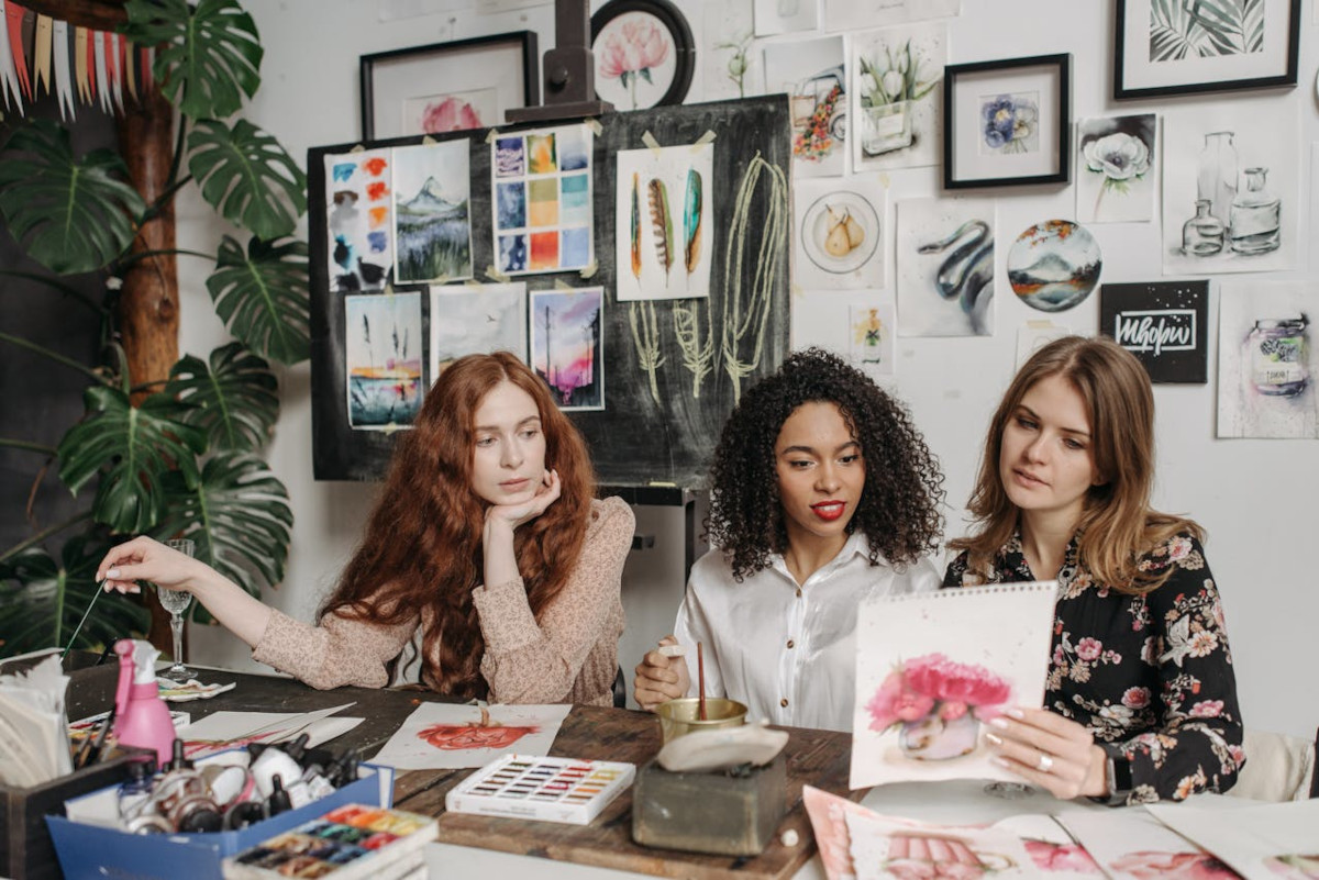 Three young ladies having painting session