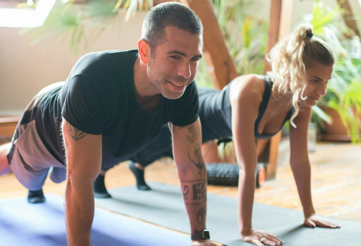 Man and woman doing light exercises, in plank position