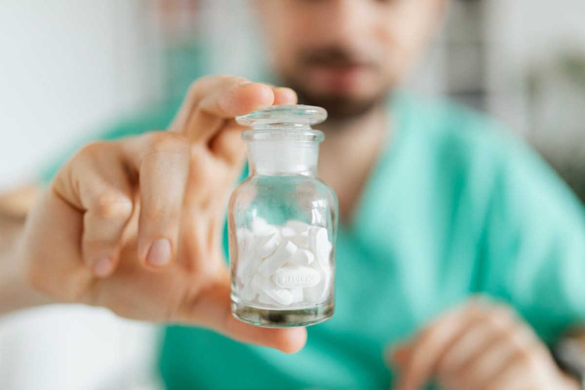 nurse holding prescription medicine in a bottle