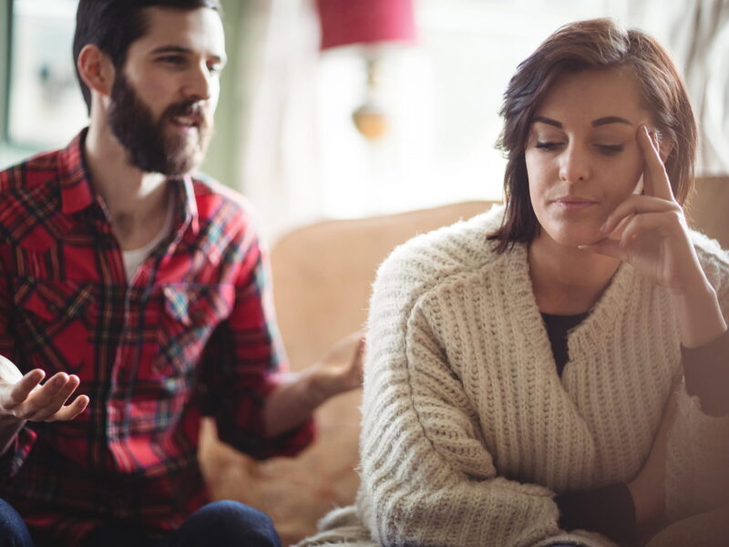 Couple arguing each other in living room