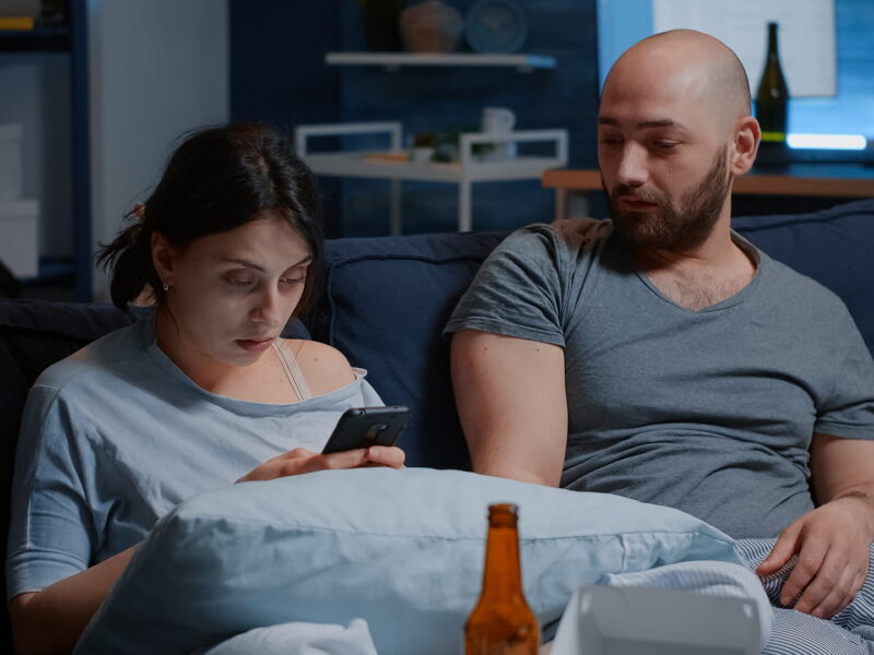 man and woman sitting on a couch