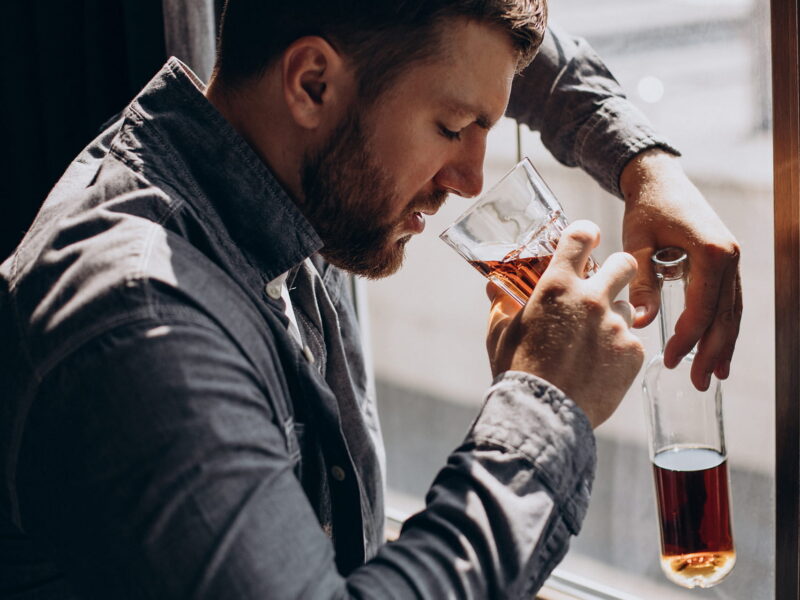 Man drinker depressed with bottle of whiskey